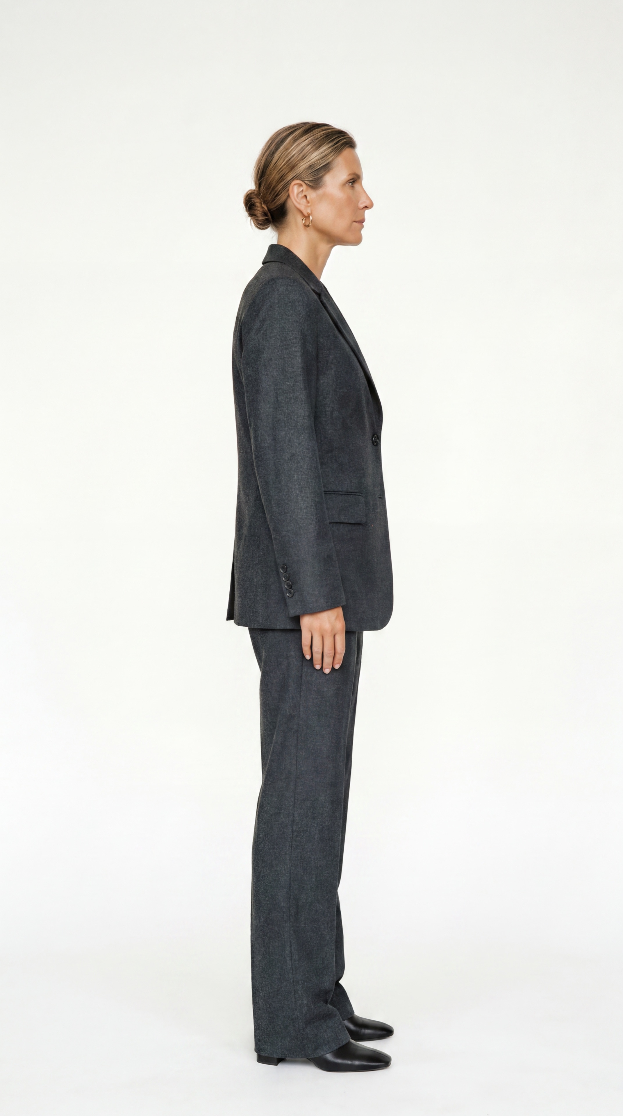 Resident in a charcoal tailored suit, profile